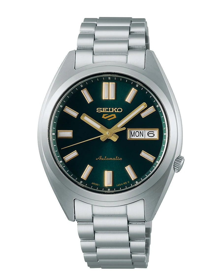 The Seiko 5 Sports Automatic SRPL57 by Seiko features a stainless steel band, green dial, gold hour markers and hands, plus a day-date display at 3 o’clock showing MON 6.