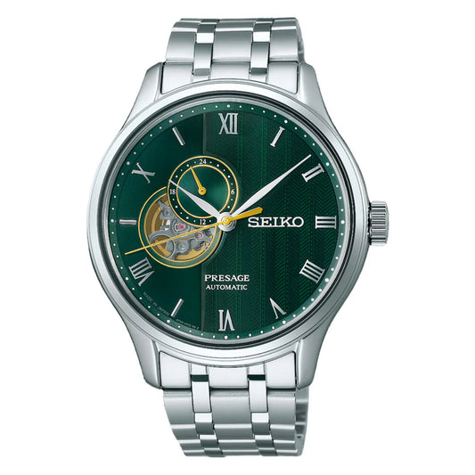 The Seiko Watch - Presage Automatic SSA463 features automatic movement, a silver stainless steel band, green dial with Roman numerals, open-heart detail, 24-hour subdial, and gold and white accents on the hands.
