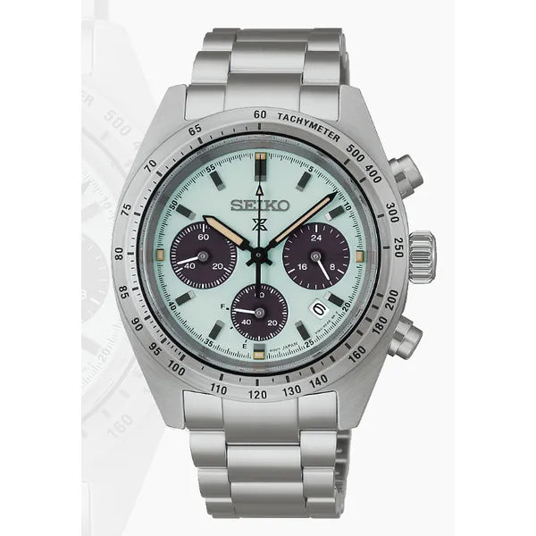 The Seiko Prospex SSC965 is a solar chronograph watch featuring a stainless steel band, light green dial with three black sub-dials, date at 4 o’clock, tachymeter bezel, and two pushers beside the crown on the right.