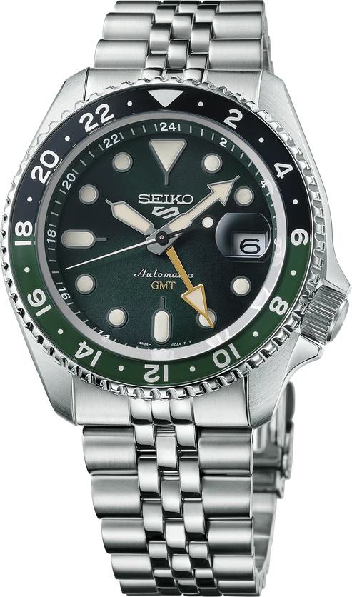 A close-up of the Seiko 5 SKX Sports Style GMT Series SSK035 watch by Seiko, featuring a green and black bezel, silver stainless steel band, dark green dial with bold markers and hands, plus a date window at 3 o'clock.