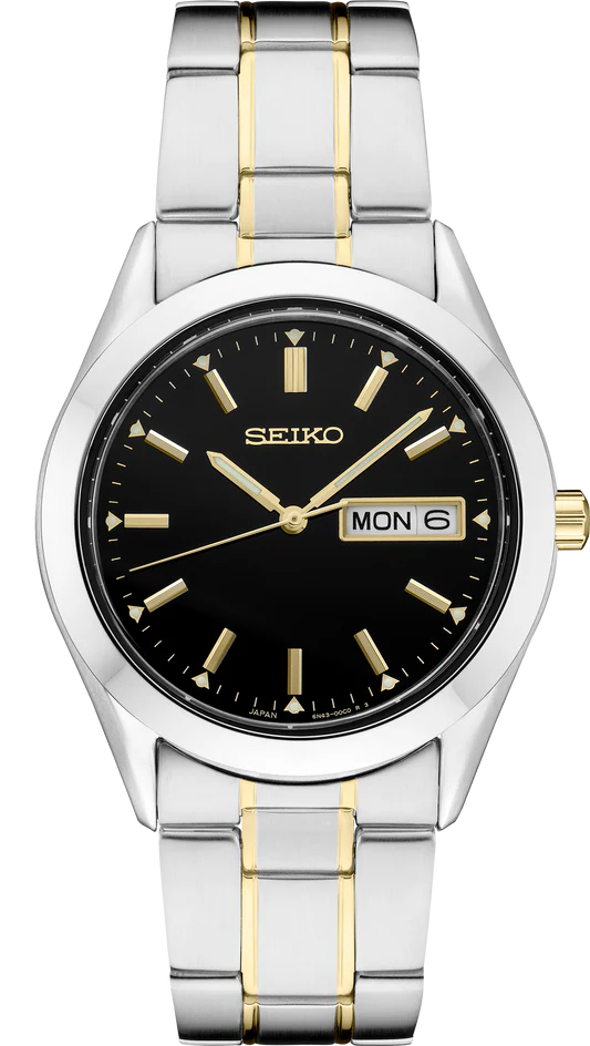 The Seiko Watch - Men's Essentials - SUR363 features a stainless steel silver and gold band, black face, gold markers and hands, plus a day-date display at 3 o’clock—an essential men’s timepiece from Seiko.