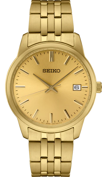 The Seiko Essentials SUR442 is a gold-tone stainless steel watch with a minimalist champagne dial, slim hour markers, three hands, and a date window at 3 o’clock.
