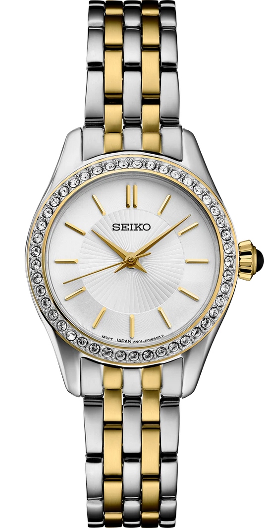 The Seiko Crystal Collection SUR540 ladies watch features a two-tone stainless steel band, round white dial, gold hour markers and hands, and a crystal-adorned bezel.