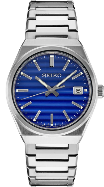 The Seiko Essentials Collection SUR555 features a silver stainless steel band, blue textured dial, silver markers and hands, sapphire crystal, and a date window at 3 o’clock.