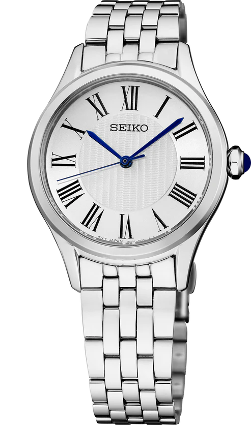 The Seiko Watch - Essentials - SUR609 is a ladies’ watch with a silver stainless steel band, white face with black Roman numerals, blue hands, sapphire crystal, and a blue-accented crown by Seiko.