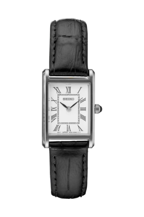 The Seiko Essentials SWR053 is a ladies' rectangular watch featuring a white dial with black Roman numerals, slim black hands, a silver case, and a black leather strap—showcasing a minimalist design.