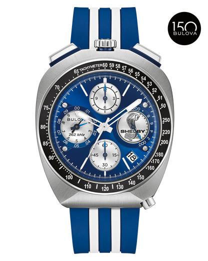 The Bulova Watch - Shelby Racing Chronograph (98B452) features a blue and silver face, three subdials, tachymeter scale, striped silicone band, Shelby Cobra logo on the dial, and 150th anniversary Bulova logo.