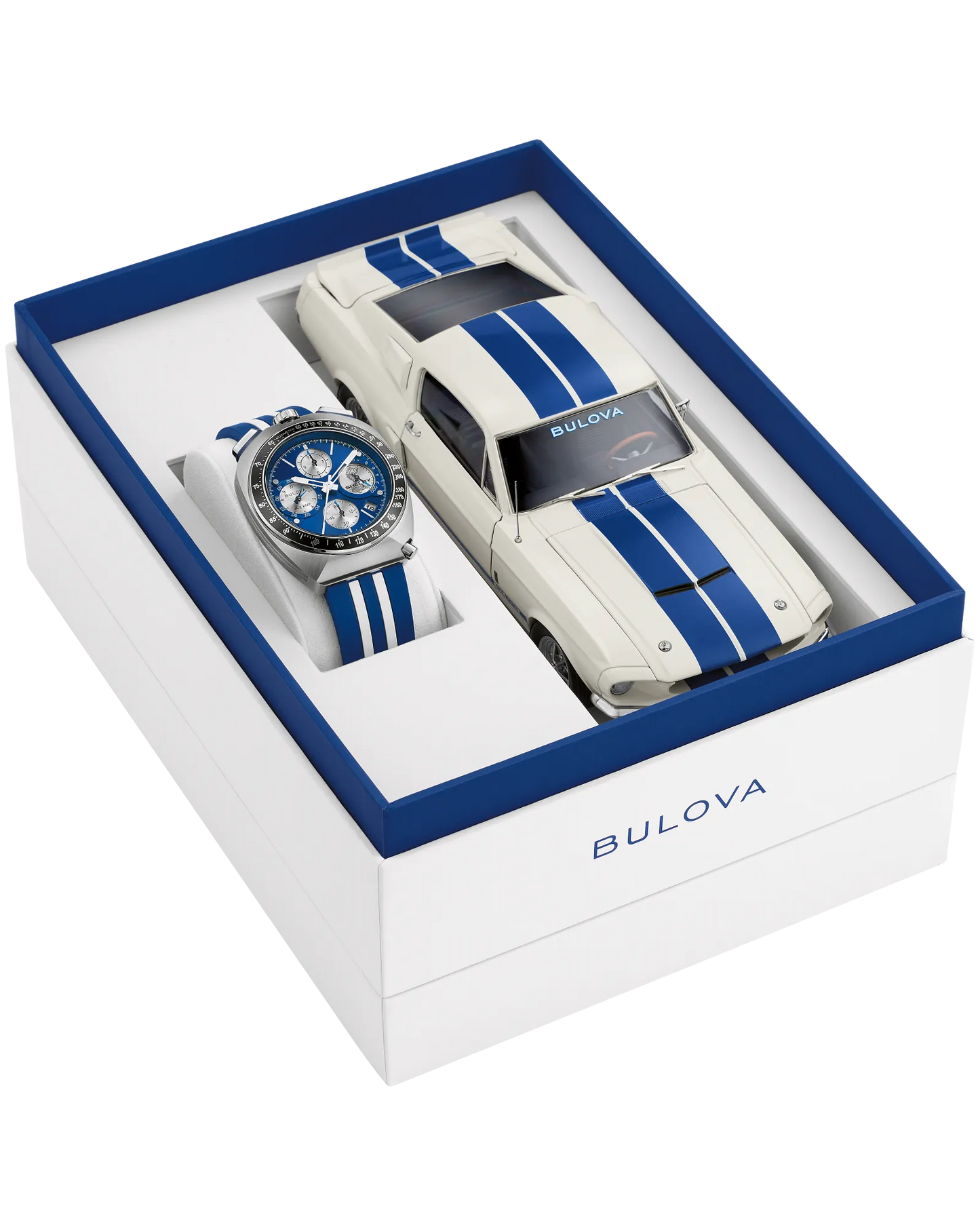 The Bulova Shelby Racing Chronograph (98B452) gift set includes a blue and white limited-edition watch and a matching white model car with blue stripes, both in an elegant box with blue accents and the Bulova logo.
