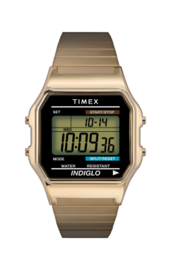 The Timex Watch - Classic Digital (T786779J) by Timex features a gold-tone expansion band, digital display showing time 10:09:36 and date 10-14, WATER RESISTANT and INDIGLO on screen, plus mode, set, start/stop, and split/reset buttons.
