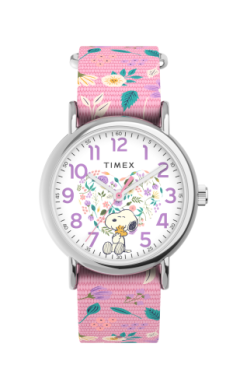 The Timex Watch - Peanuts Weekender (TW2V77800JT) features a pink fabric strap, white dial with Snoopy and headphones, purple numbers and hands, and a silver case—offering a playful, stylish look for women.