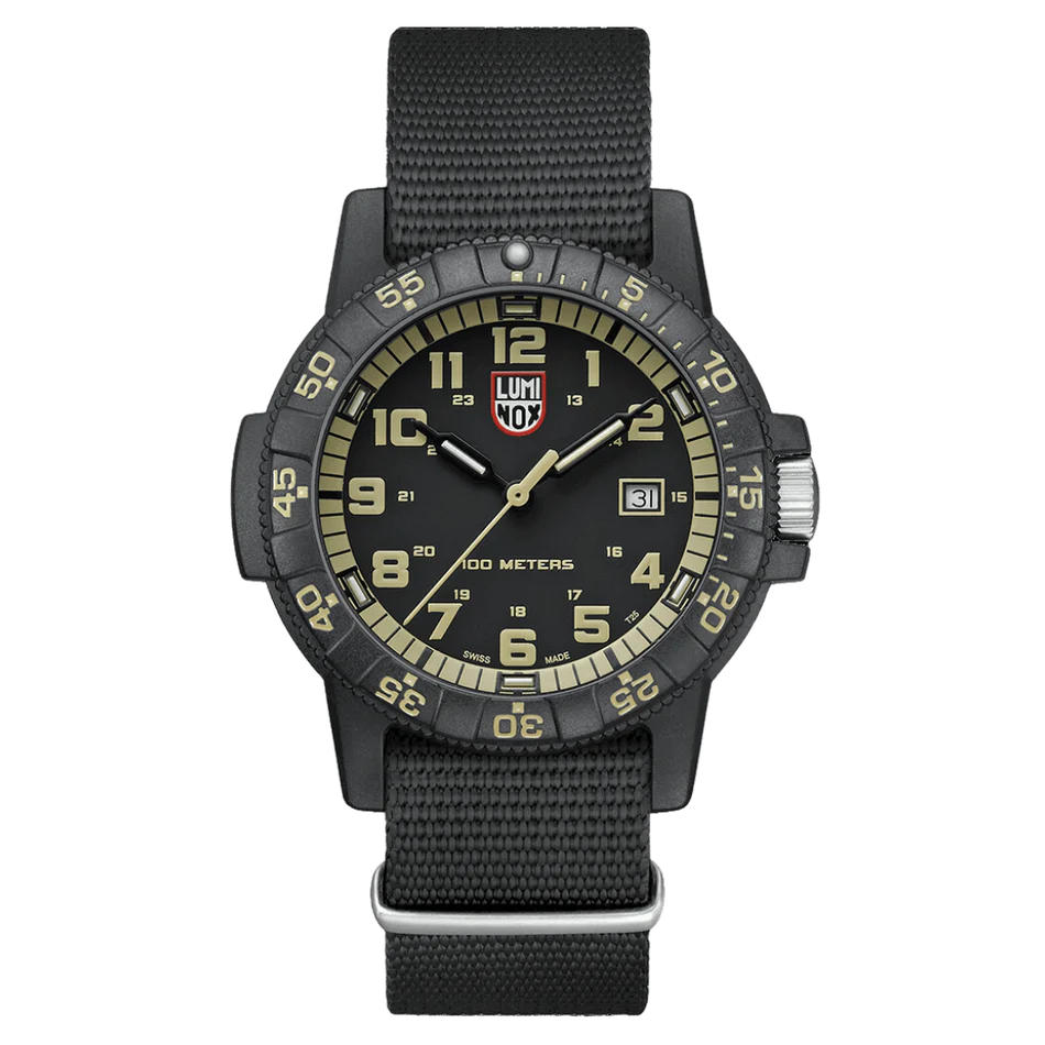The Luminox Watch - Leatherback Sea Turtle Giant XS.0333 features a beige dial with bold Arabic numerals, date window at 3 o’clock, minute-marked bezel, 100m water resistance, and a durable black nylon strap.