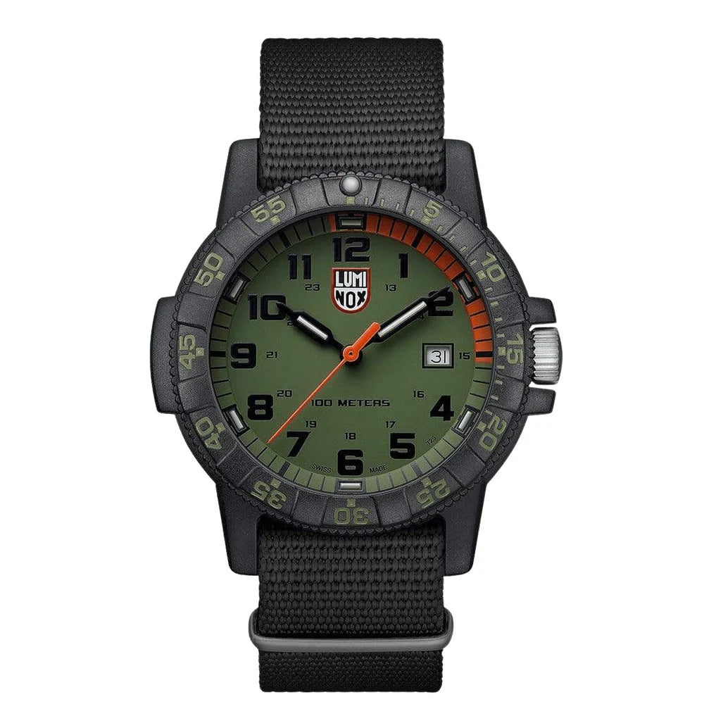 The Luminox Watch - Leatherback Sea Turtle Giant - XS.0337 features a CARBONOX black case, olive green dial with bold black numerals and orange accents, black fabric strap, date at 3 o’clock, and is water-resistant to 100 meters.