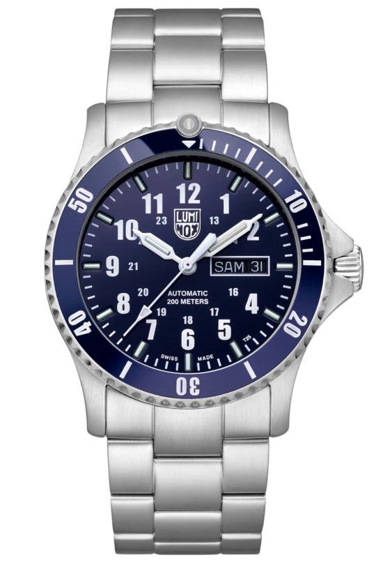 The Luminox Watch - Automatic Sport Timer - XS.0924 is a silver stainless steel timepiece with blue bezel and dial, white hour markers, three hands, day/date display, and water resistance up to 200 meters.