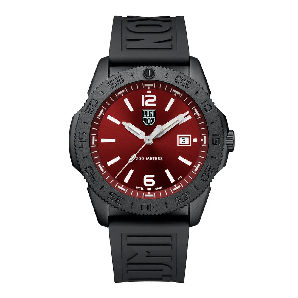 The Luminox Pacific Diver XS.3135.B is a black wristwatch with a red dial, bold white numerals, “Swiss Made” label, date window at 3 o’clock, “200 METERS” above 6 o’clock, and a black rubber strap embossed with “LUMI” near the case.