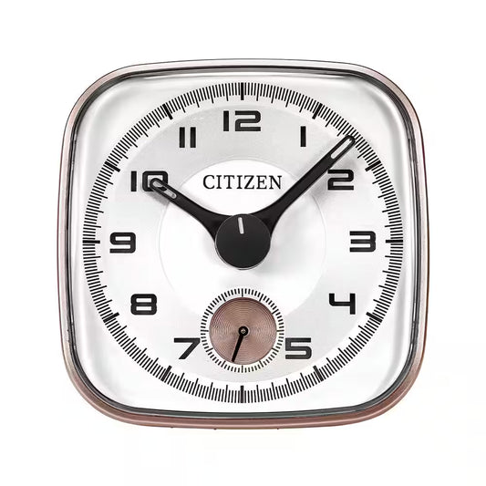 A square CC2102 CITIZEN ALARM CLOCK by Citizen displays the time as 10:08, featuring a small second hand dial at the bottom. The clock has black numbers and hands on a white face, complemented by a classic chrome plated alarm.