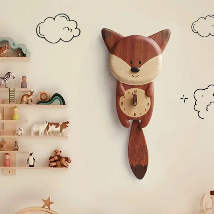 The Senser Woodcraft - Wooden Wall Clock - Fox - LL72 by Senser Woodcraft hangs on a light wall with cloud drawings, while nearby shelves hold cute animal figurines and small toys.
