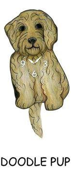 Pink Cloud’s Doodle Pup - Wagging Tail Clocks feature a cute, light brown doodle puppy design with black eyes and nose, clock numbers on its chest, a hanging tail, and “DOODLE PUP” text below.
