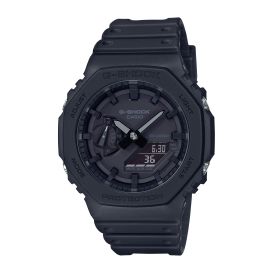 The Casio G-Shock Watch - Blackout - GA2100-1A1 from VLC Distribution Co. features a rugged round face, thick bezel, black band, small digital date/time display, and sporty design—built for active lifestyles.