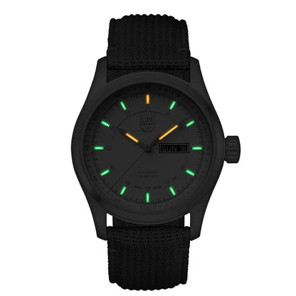 The Luminox Watch - Atacama Field Automatic - XL.1907.NF features a black case, fabric band, glowing green and orange markers, day-date display (SUN 31), and Swiss automatic movement with illuminated hands for night visibility.