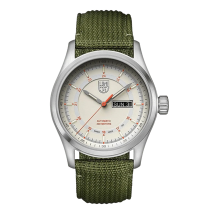 A Luminox watch with a white dial, orange accents, and a green textile strap. The watch has a stainless steel case and a sapphire crystal glass cover.