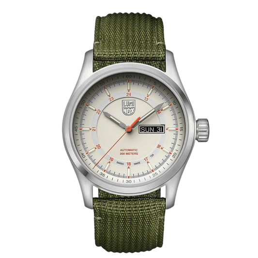 A Luminox watch with a white dial, orange accents, and a green textile strap. The watch has a stainless steel case and a sapphire crystal glass cover.