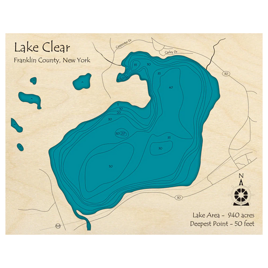 The Lake Art "Lake Clock - Lake Clear Franklin County, NY" features a detailed map with contour lines for water depths, nearby roads, and a compass. The lake covers 940 acres and is 50 ft deep—an ideal custom wooden wall clock.