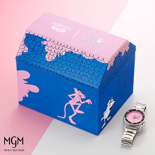 Seiko 5 Pink Panther Limited Edition SRPM07 watch with a pink face and silver-tone link bracelet, positioned next to a blue and pink rectangular box featuring a Pink Panther illustration.