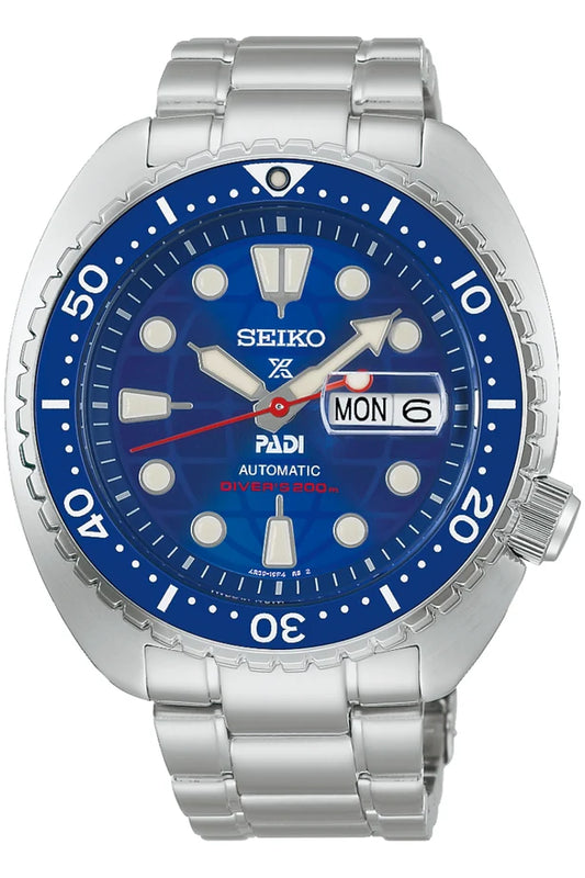 Introducing the Seiko Watch - Limited Edition PADI Prospex Sea - HBB002: a striking silver dive watch featuring a blue dial, bold white markers, and a durable metal band. The day and date window displays MON 6, complemented by red “Divers 200m” text on the lower half of the dial. Engineered for precision, this exclusive Seiko timepiece boasts a reliable automatic movement—perfect for diving enthusiasts.